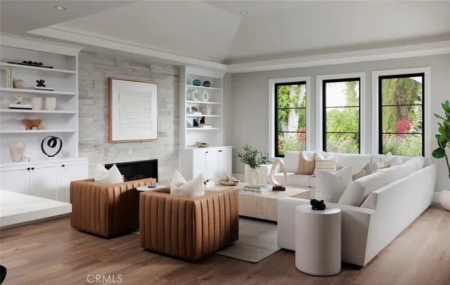 a living room with furniture fireplace and large windows