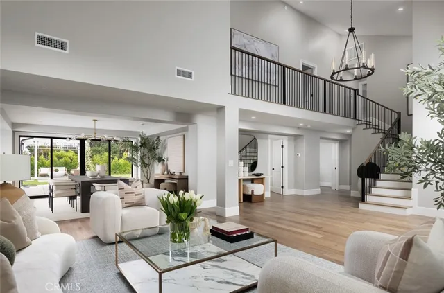 a living room with furniture and floor to ceiling windows