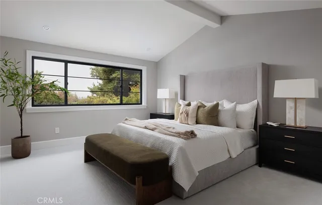 a bedroom with a large bed and a potted plant