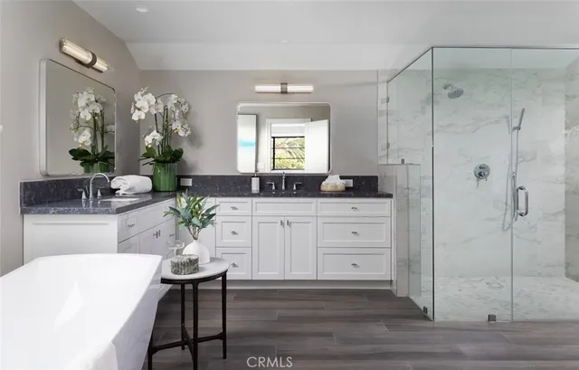 a spacious bathroom with a double vanity sink and a mirror