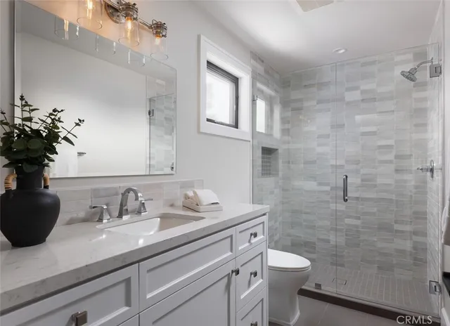 a bedroom with a large bed and a potted plant