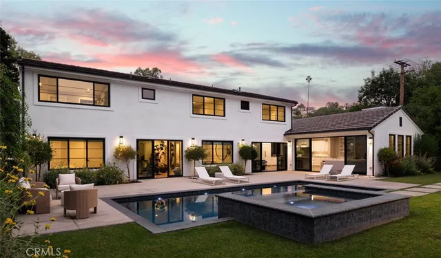 a view of house with a big yard couches and potted plants