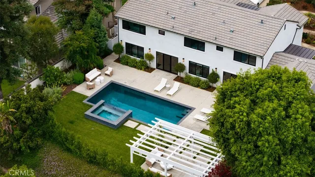 a view of house with outdoor space and swimming pool