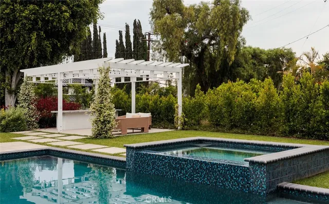 a view of house with swimming pool and furniture