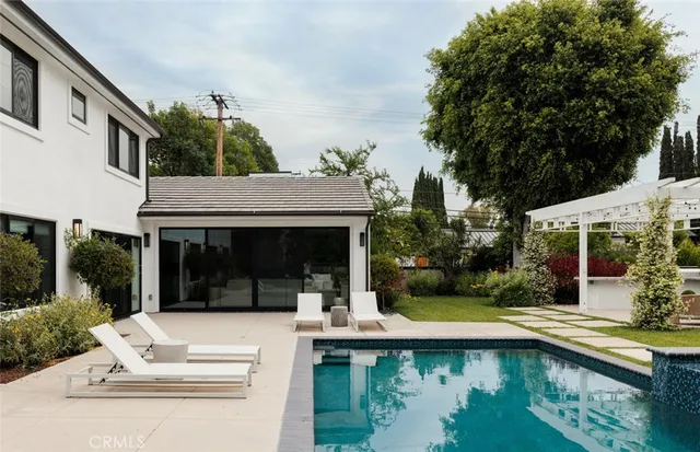 a view of house with swimming pool and porch