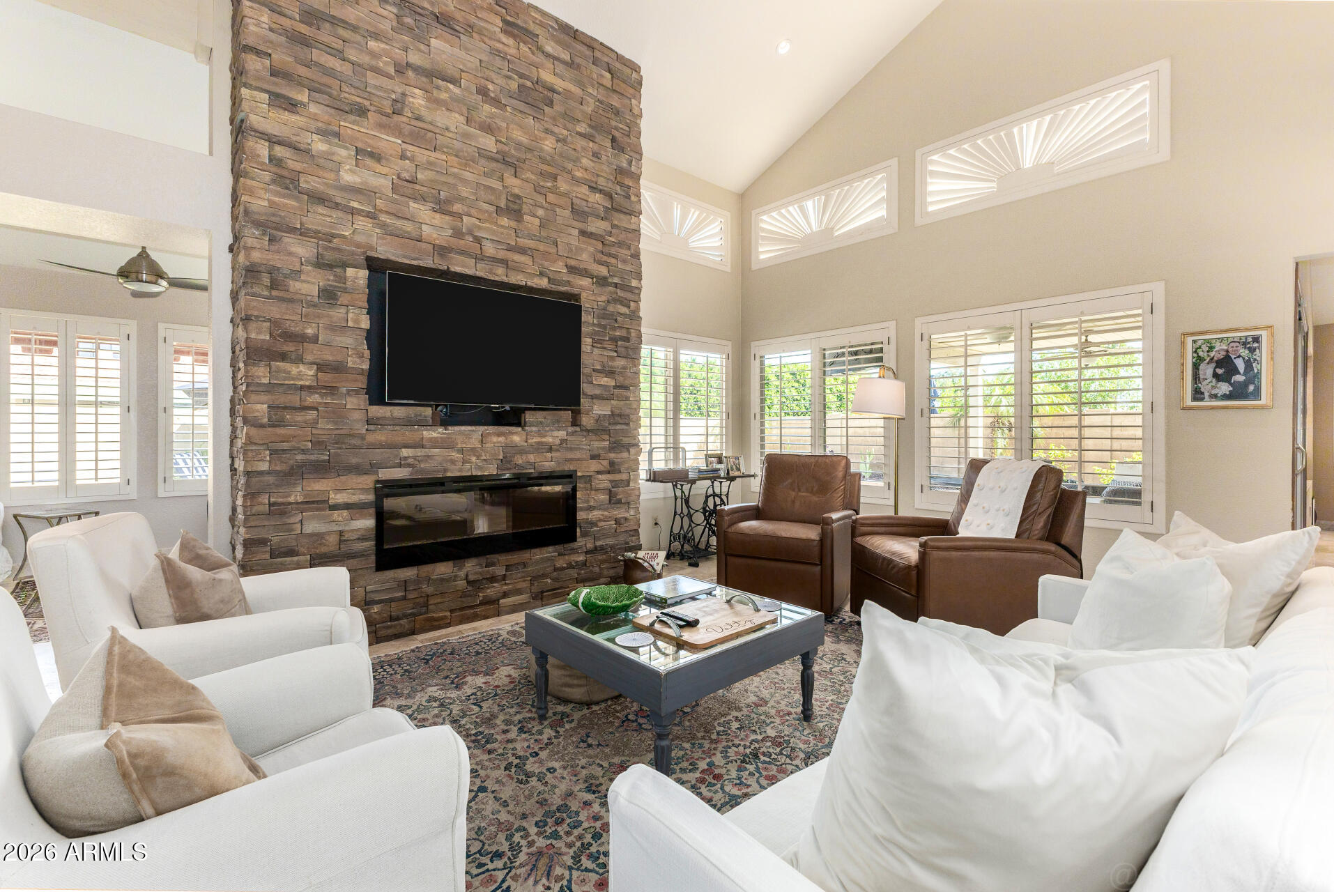 1942 East Krista Way Tempe, AZ 85284 - Photo 16 of 51 a living room with furniture a fireplace and a flat screen tv