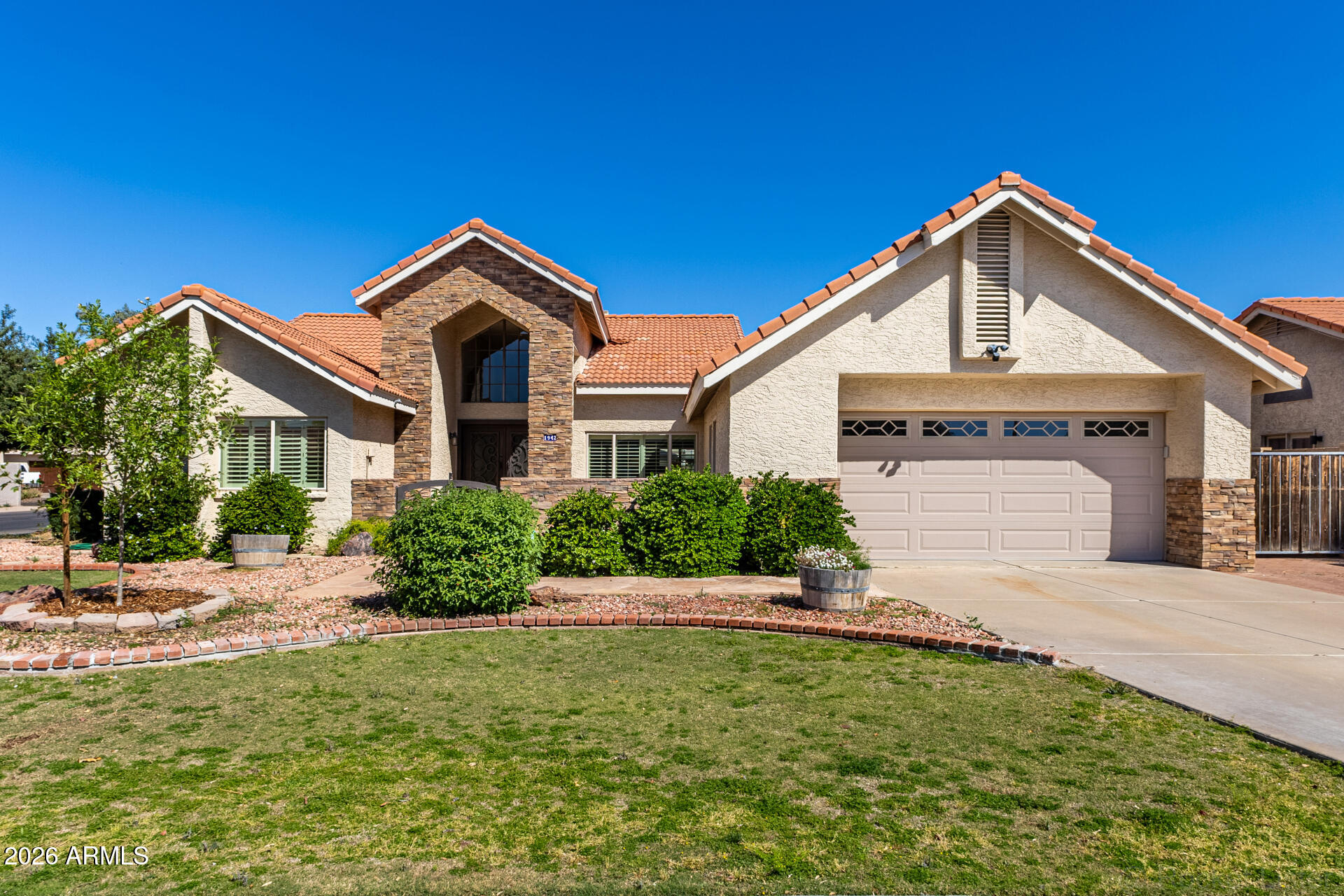 1942 East Krista Way Tempe, AZ 85284 - Photo 2 of 51 a front view of a house with a yard and garage