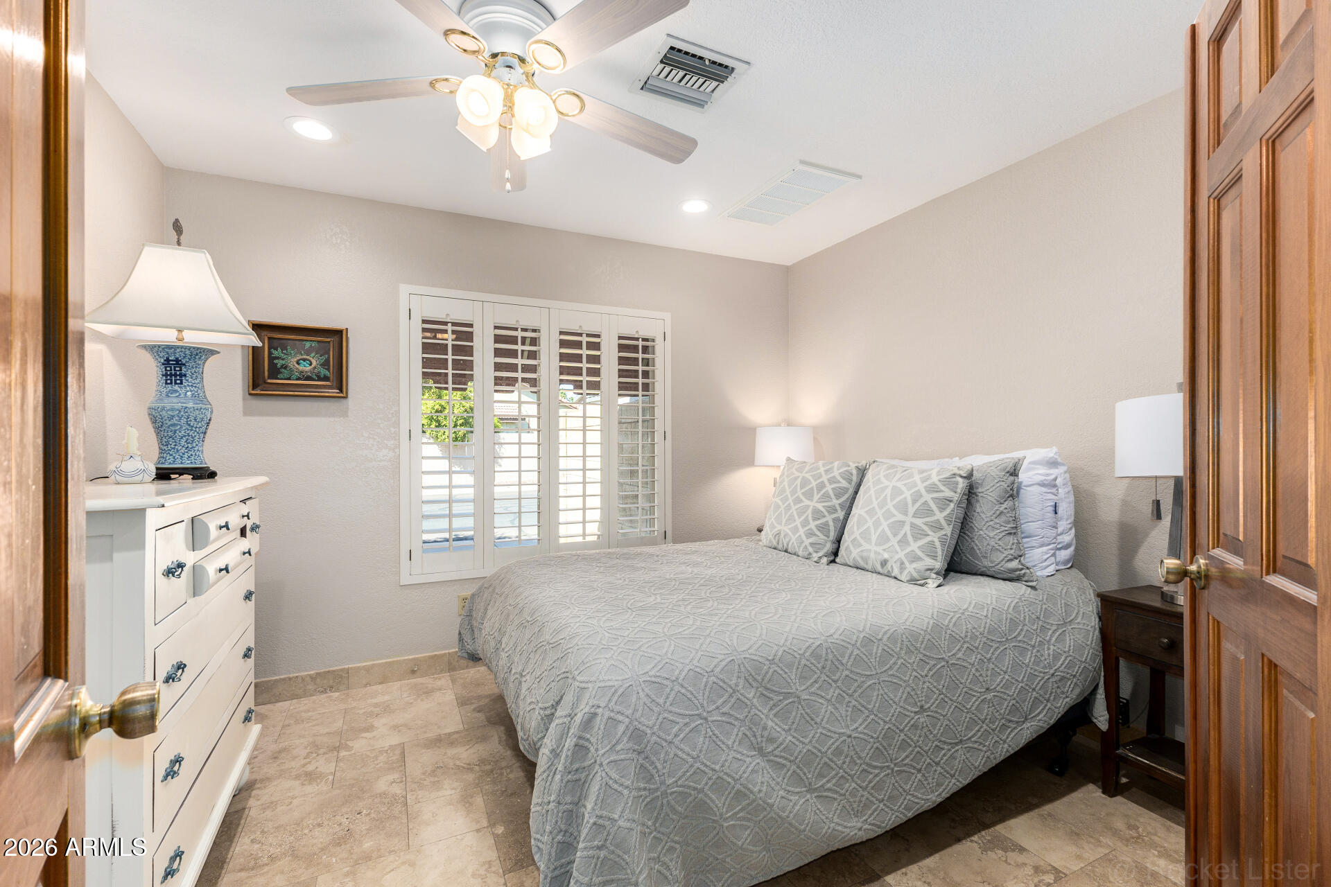 1942 East Krista Way Tempe, AZ 85284 - Photo 28 of 51 a bedroom with a large bed and a chandelier