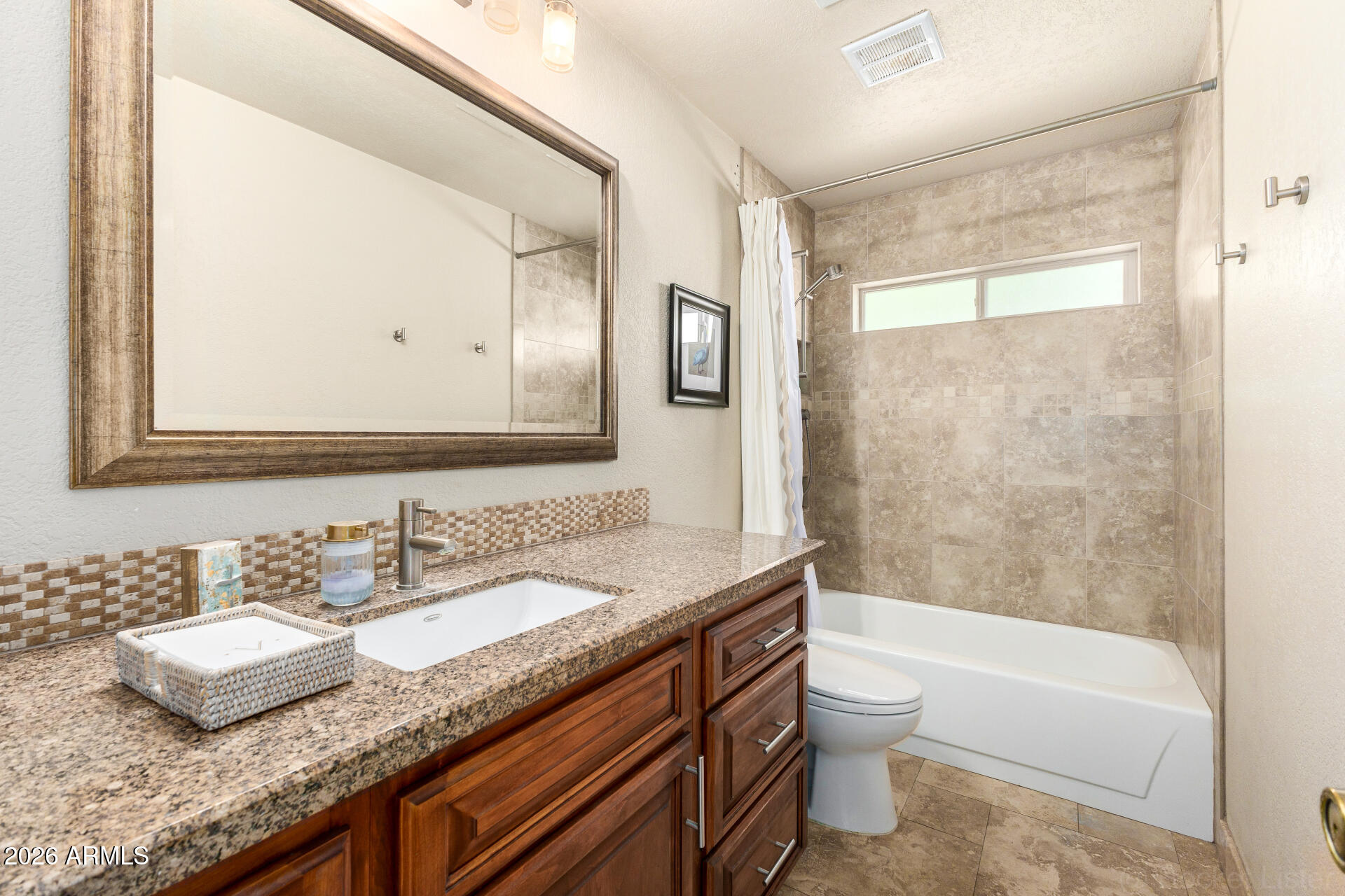1942 East Krista Way Tempe, AZ 85284 - Photo 30 of 51 a bathroom with a granite countertop sink a toilet and a bathtub