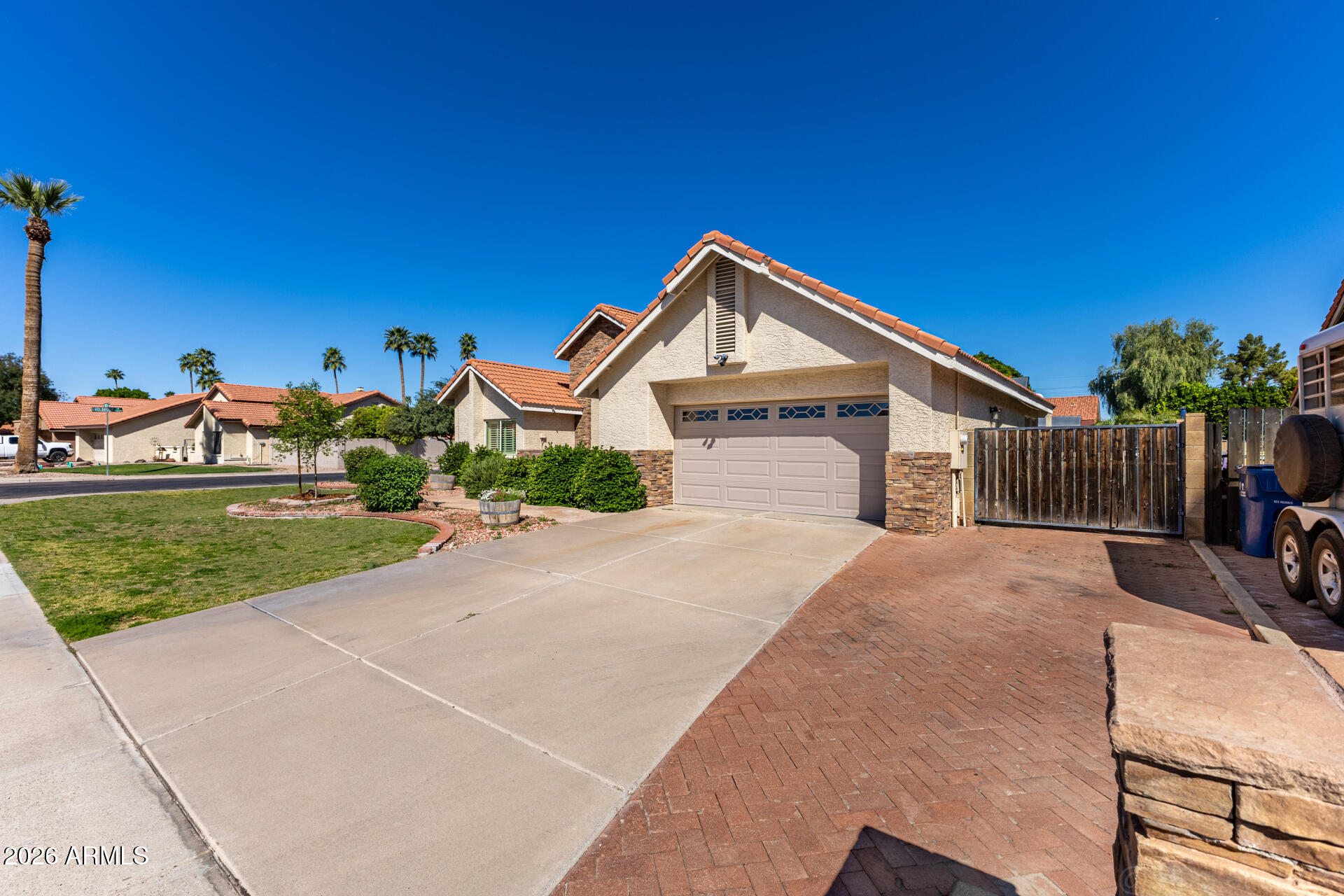 1942 East Krista Way Tempe, AZ 85284 - Photo 47 of 51 a front view of a house with a yard and garage