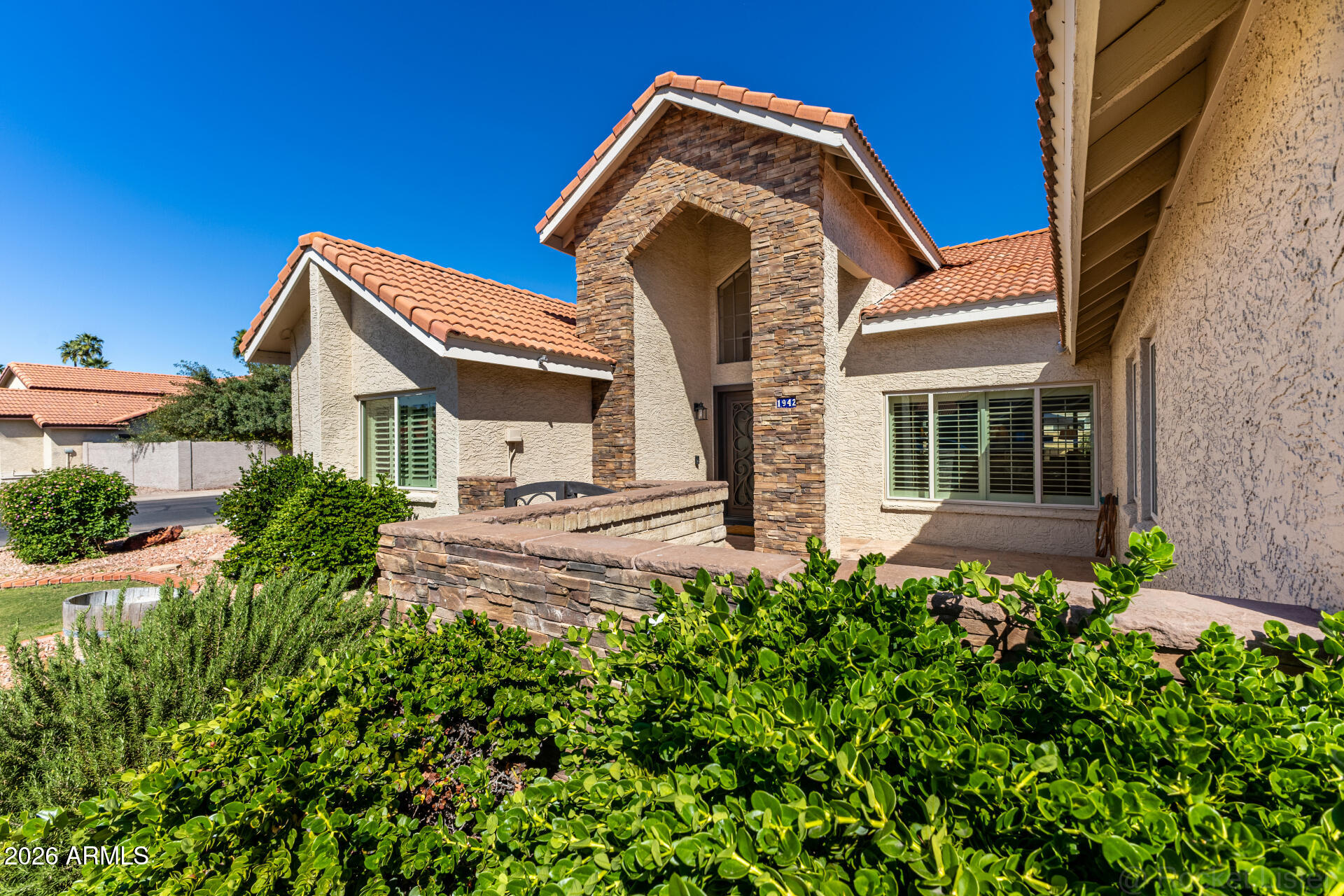 1942 East Krista Way Tempe, AZ 85284 - Photo 49 of 51 a view of a house with a small yard plants and a large tree