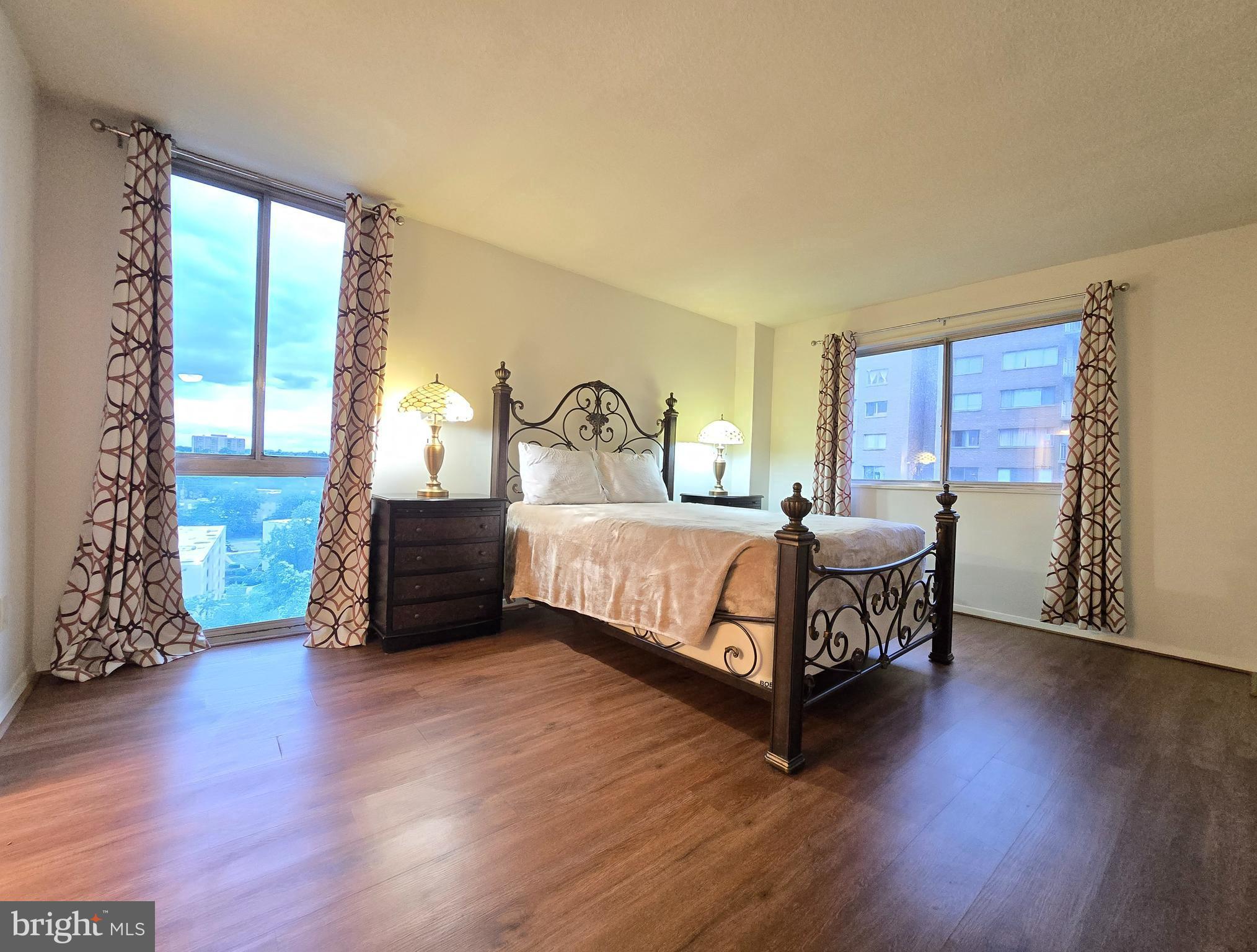 1836 Metzerott Road, Unit 1524 Hyattsville, MD 20783 - Photo 19 of 22 a bedroom with a bed window and wooden floor
