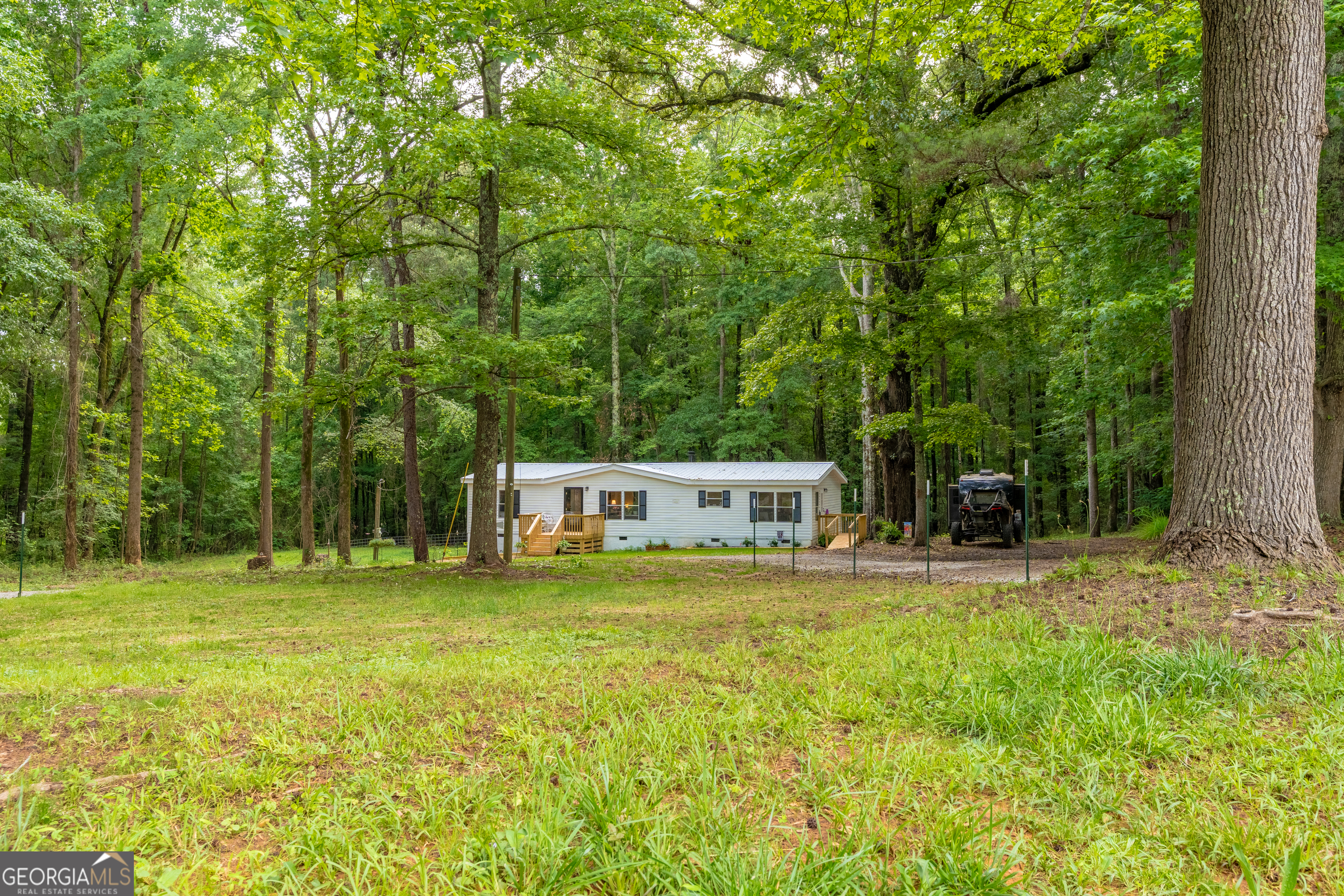 452 Aikenton Road Monticello, GA 31064 - Photo 40 of 47 a view of a house with a yard and sitting area
