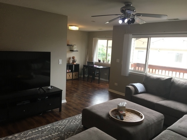 Undisclosed Address Palatine, IL 60074 - Photo 3 of 10 a living room with furniture a rug and a chandelier