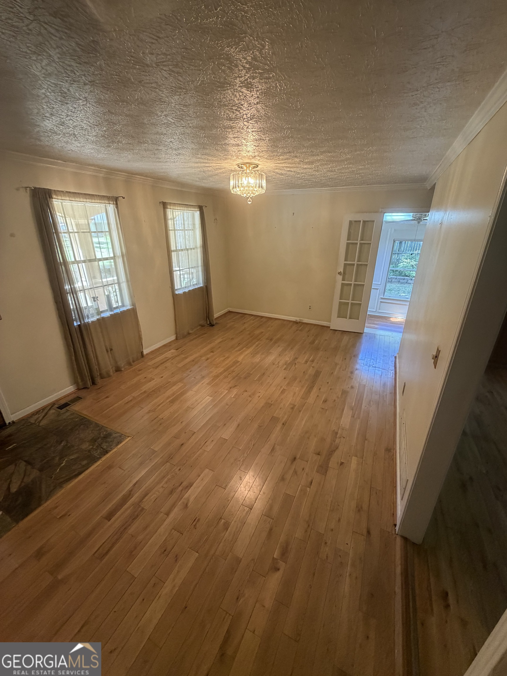 4276 Cedar Valley Court Conley, GA 30288 - Photo 7 of 13 a view of an empty room with wooden floor and a window