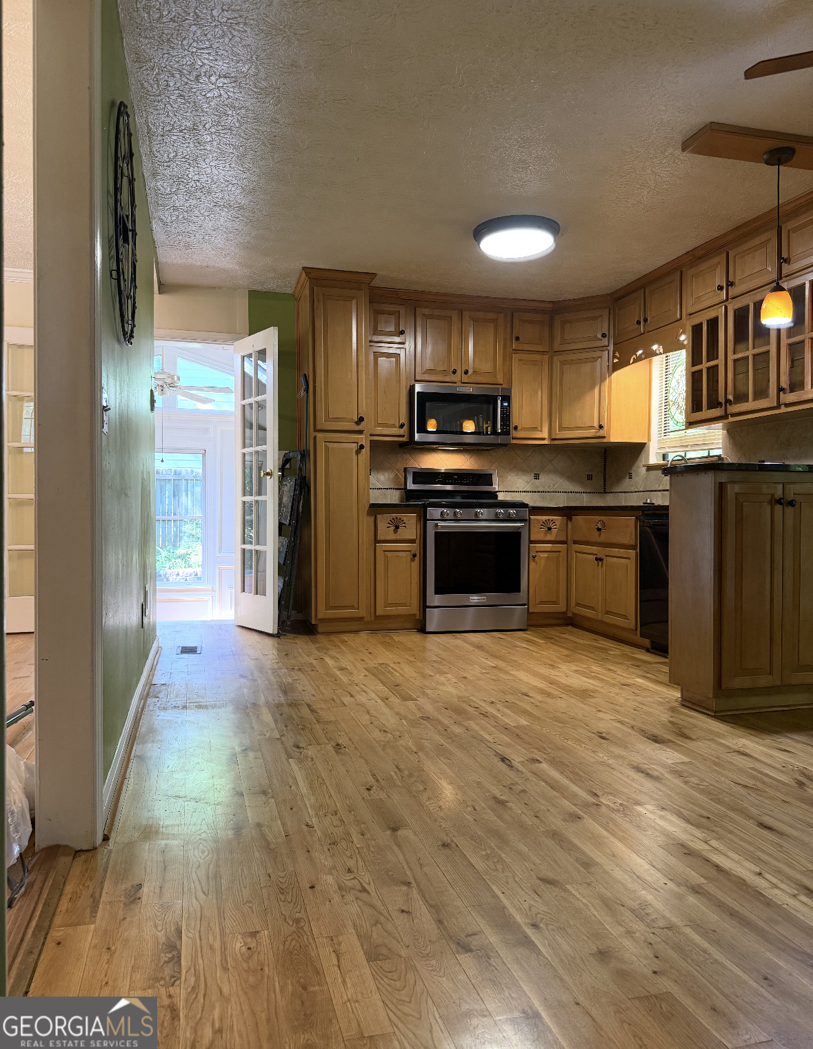 4276 Cedar Valley Court Conley, GA 30288 - Photo 9 of 13 a large kitchen with kitchen island granite countertop a large counter top stainless steel appliances and cabinets