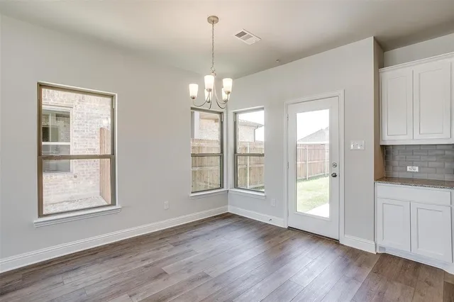 a kitchen with stainless steel appliances granite countertop a stove and a white cabinets