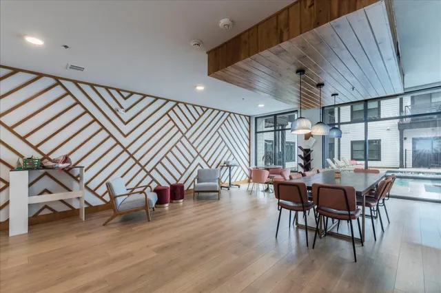 a dining room with furniture and wooden floor
