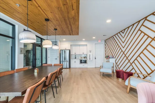 a living room with furniture a flat screen tv and a large window