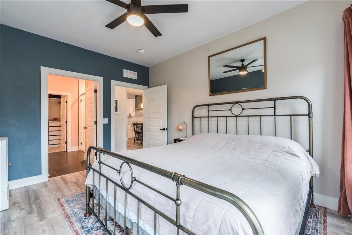 3101 Govalle Avenue, Unit 220 Austin, TX 78702 - Photo 10 of 26 a bedroom with a bed and wooden floor