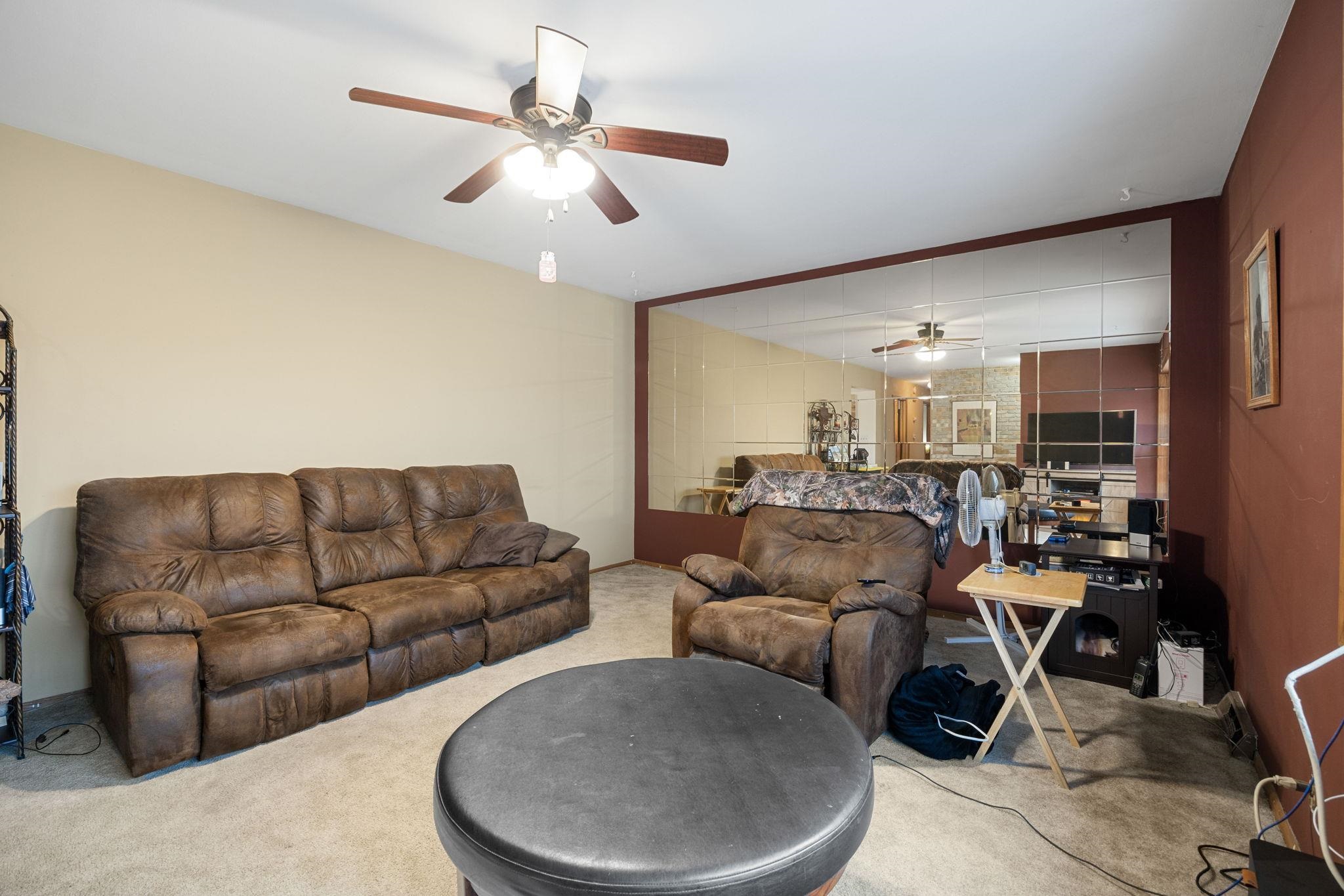 6594 South Meridian Road Rockford, IL 61102 - Photo 8 of 63 a living room with furniture and a chandelier
