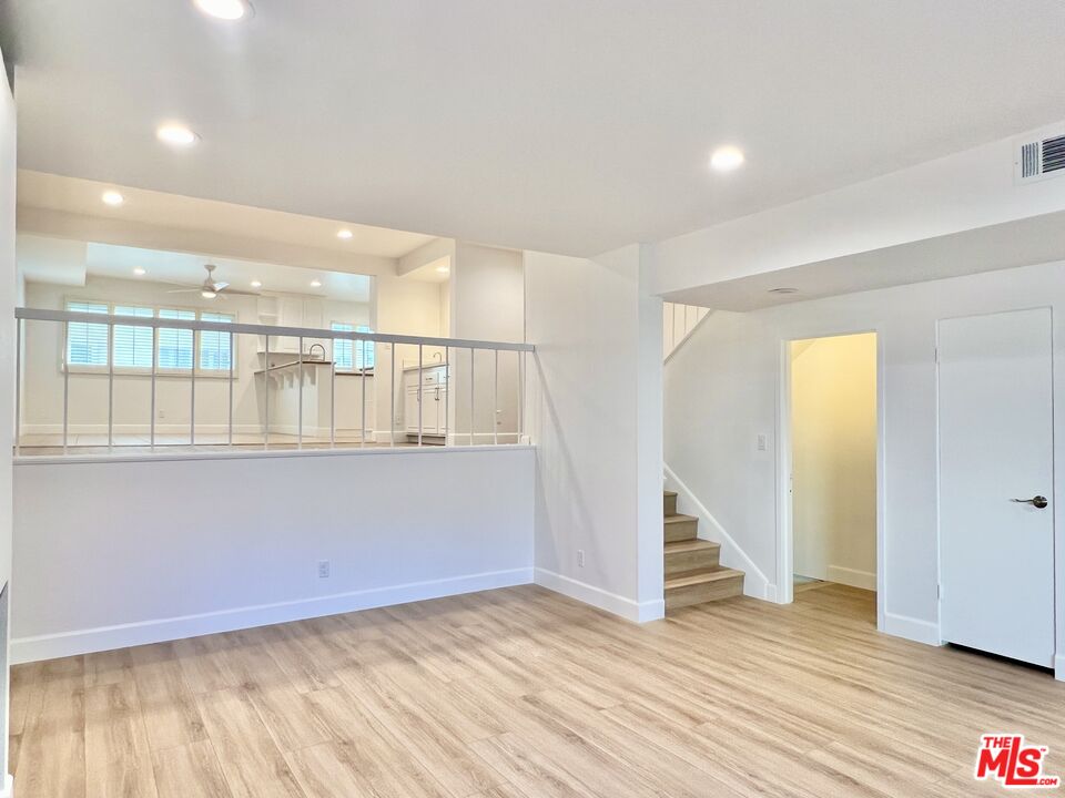 13218 Fiji Way, Unit B Marina del Rey, CA 90292 - Photo 11 of 63 a view of an empty room with wooden floor and stairs