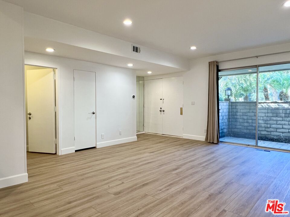 13218 Fiji Way, Unit B Marina del Rey, CA 90292 - Photo 12 of 63 an empty room with wooden floor and sliding door