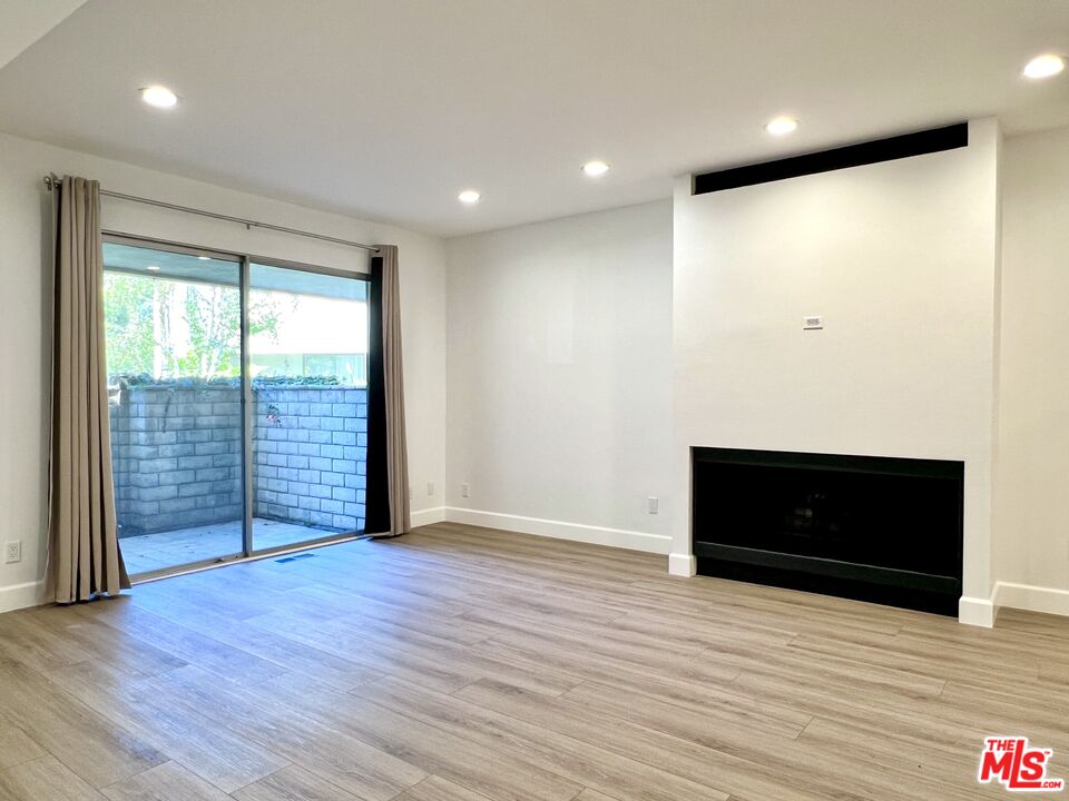 13218 Fiji Way, Unit B Marina del Rey, CA 90292 - Photo 13 of 63 an empty room with wooden floor and windows
