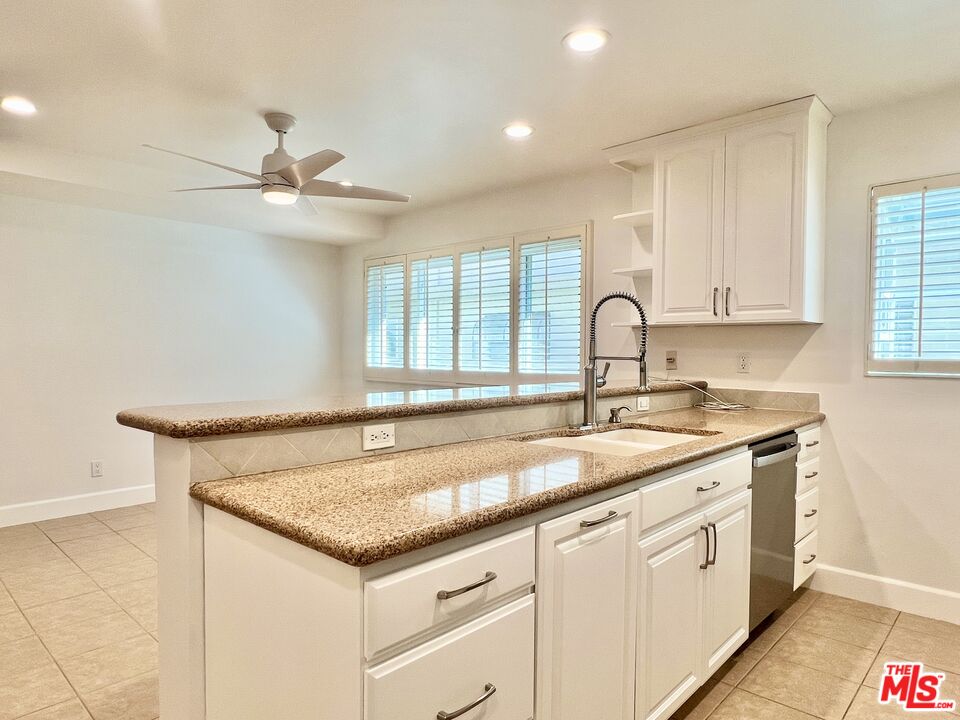 13218 Fiji Way, Unit B Marina del Rey, CA 90292 - Photo 20 of 63 a kitchen with granite countertop a sink and white cabinets