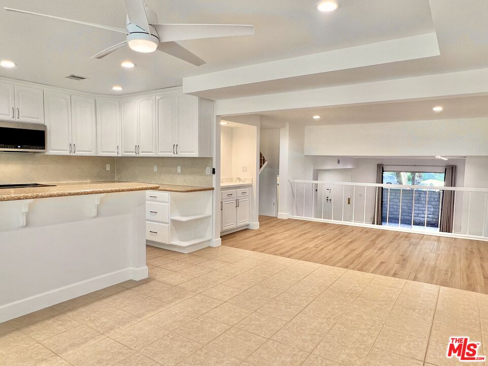 13218 Fiji Way, Unit B Marina del Rey, CA 90292 - Photo 25 of 63 a large kitchen with kitchen island a sink stainless steel appliances and cabinets