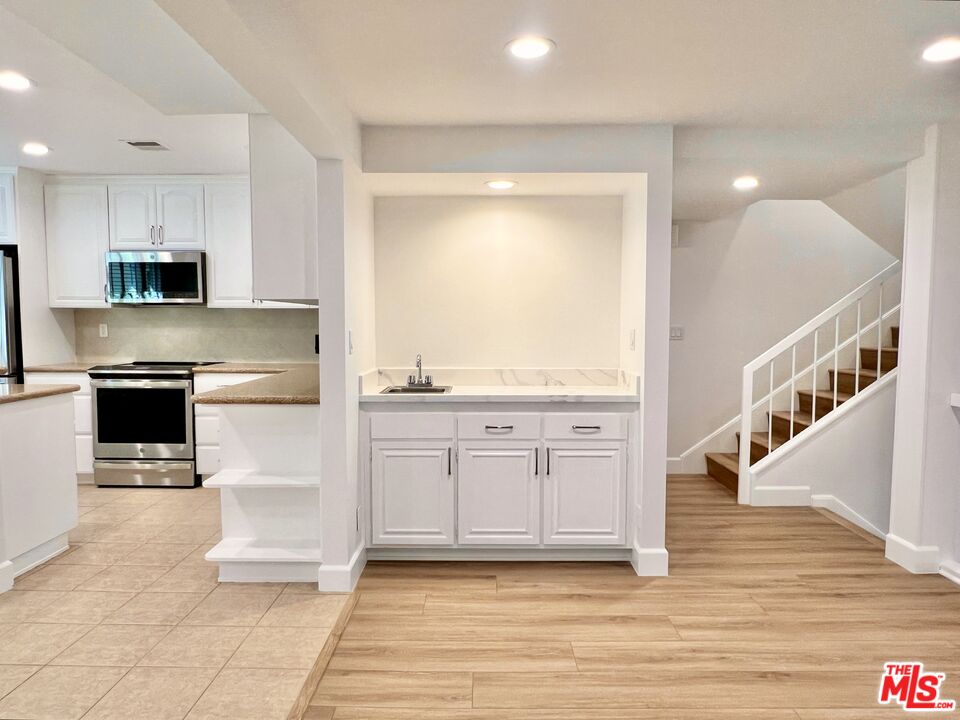 13218 Fiji Way, Unit B Marina del Rey, CA 90292 - Photo 26 of 63 a kitchen with stainless steel appliances granite countertop a stove a sink and a refrigerator