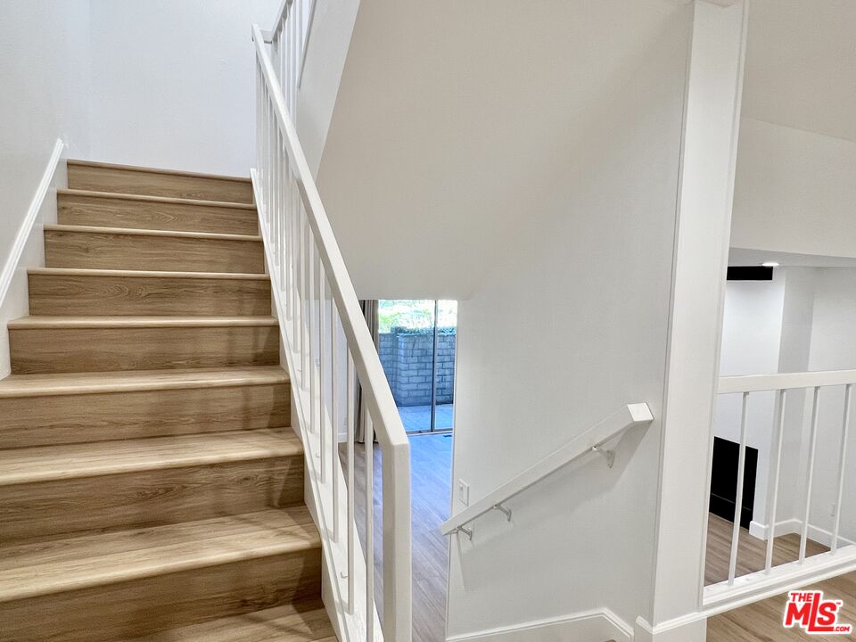 13218 Fiji Way, Unit B Marina del Rey, CA 90292 - Photo 30 of 63 a view of staircase with white walls and a floor to ceiling window