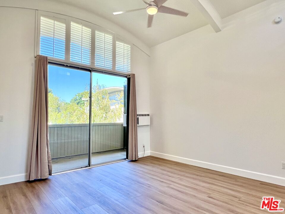 13218 Fiji Way, Unit B Marina del Rey, CA 90292 - Photo 31 of 63 an empty room with wooden floor and windows