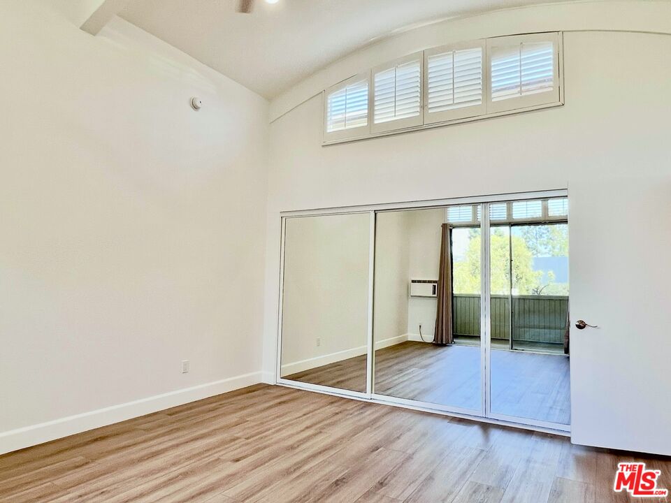 13218 Fiji Way, Unit B Marina del Rey, CA 90292 - Photo 32 of 63 an empty room with wooden floor and windows