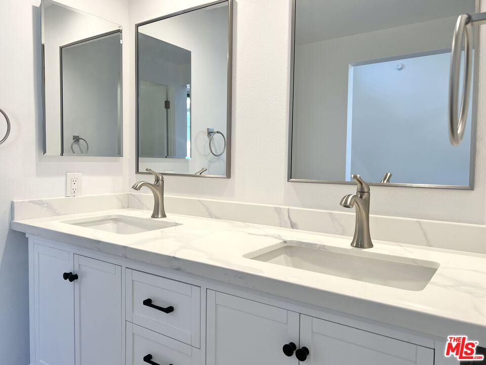 13218 Fiji Way, Unit B Marina del Rey, CA 90292 - Photo 35 of 63 a bathroom with a sink and a mirror