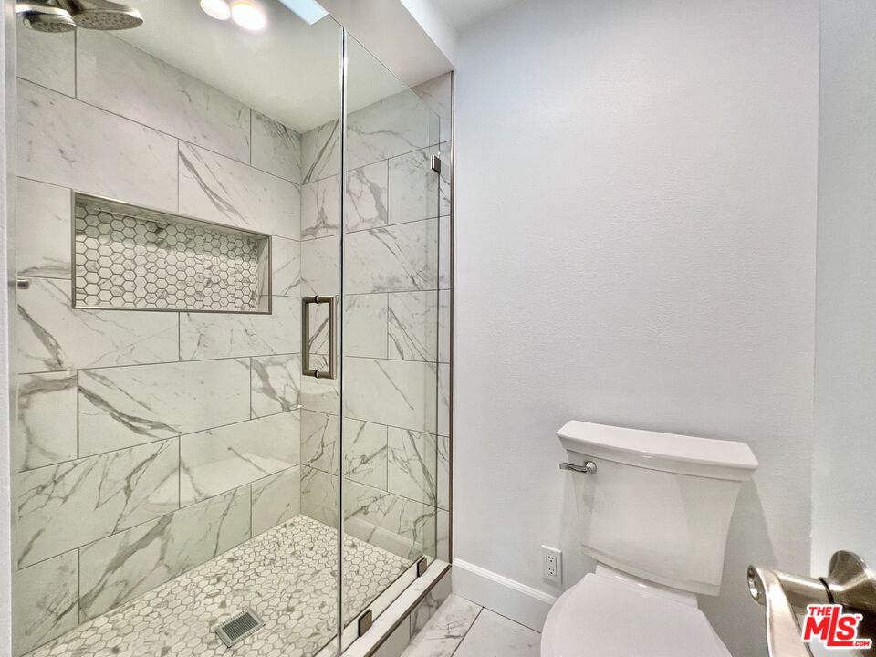 13218 Fiji Way, Unit B Marina del Rey, CA 90292 - Photo 36 of 63 a white toilet sitting next to a shower