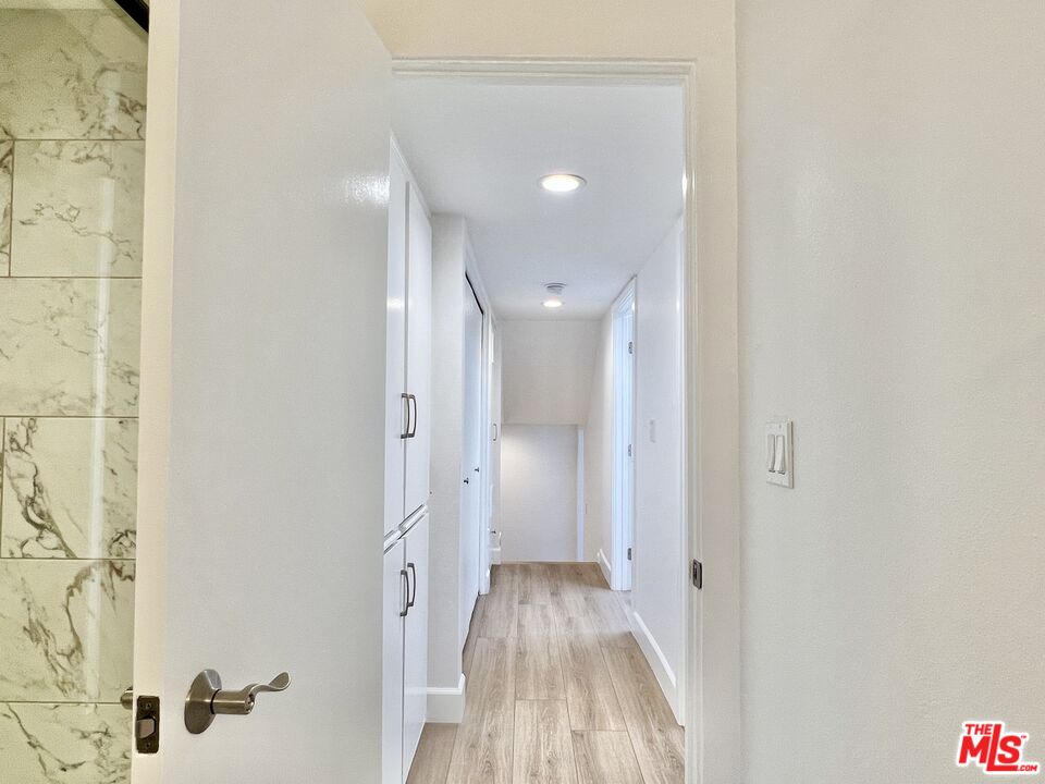 13218 Fiji Way, Unit B Marina del Rey, CA 90292 - Photo 42 of 63 a view of a hallway with wooden floor and a bathroom