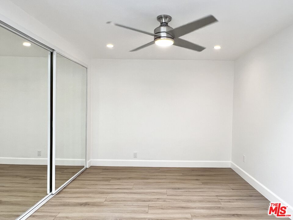 13218 Fiji Way, Unit B Marina del Rey, CA 90292 - Photo 47 of 63 an empty room with wooden floor fan and windows