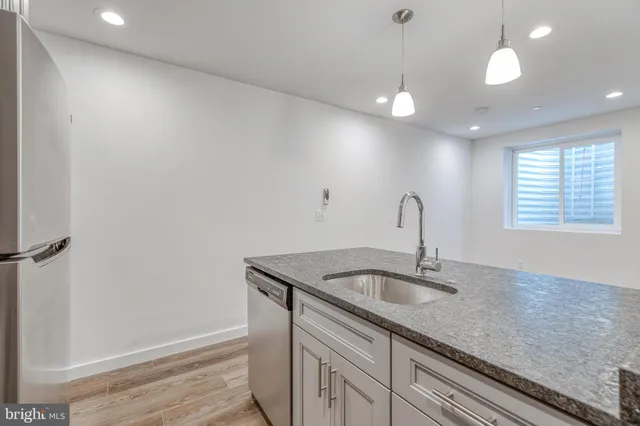 a kitchen with a sink and chandelier
