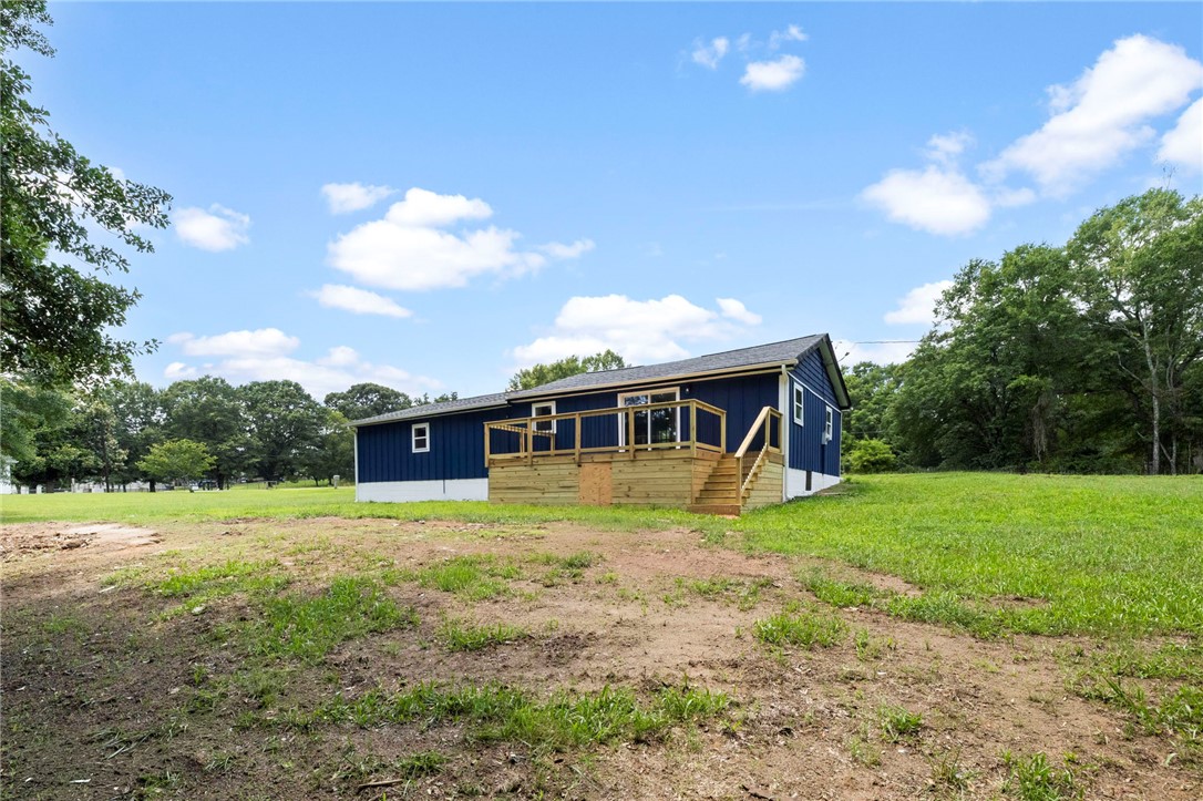 418 Old River Road Pelzer, SC 29669 - Photo 27 of 29 A newly constructed back deck provides ample space for outdoor enjoyment and overlooks a spacious, green yard.