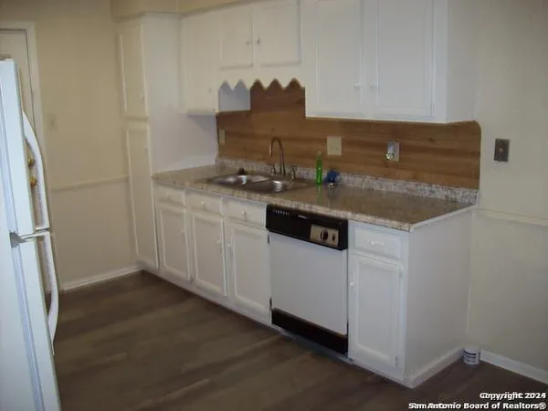a kitchen with a sink and cabinets