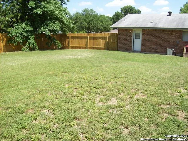 a backyard of a house with lots of green space