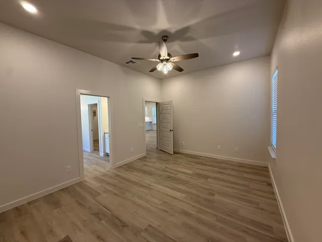 an empty room with fan and a ceiling fan