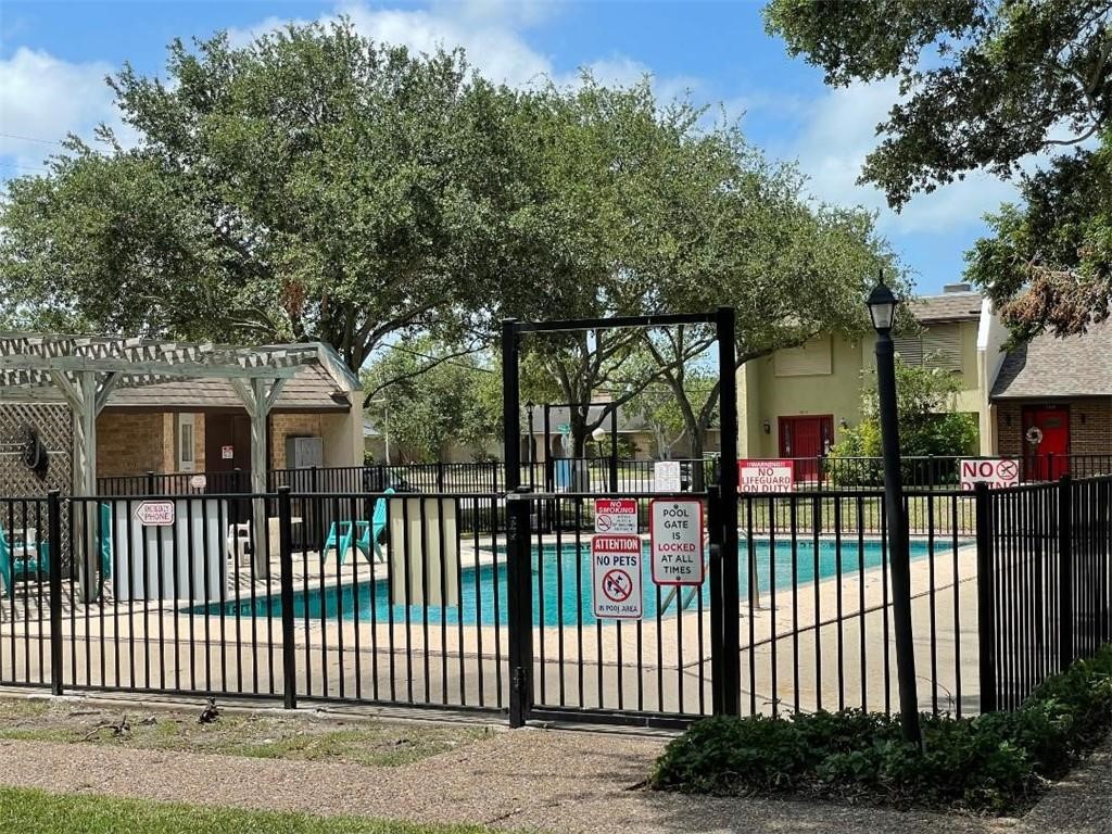 5444 Stonegate Way Corpus Christi, TX 78411 - Photo 13 of 13 a view of a white house with a large window and plants