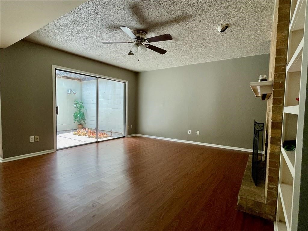 5444 Stonegate Way Corpus Christi, TX 78411 - Photo 3 of 13 a view of an empty room with a window and wooden floor