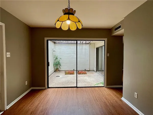 a view of hallway with wooden floor