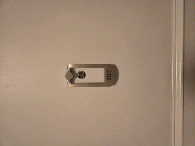 an empty room with wooden floor and closet area