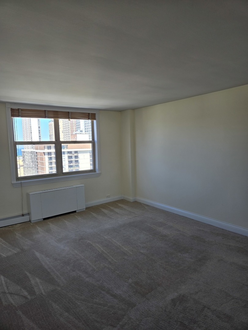 40 East Cedar Street, Unit 21C Chicago, IL 60611 - Photo 23 of 33 an empty room with a window