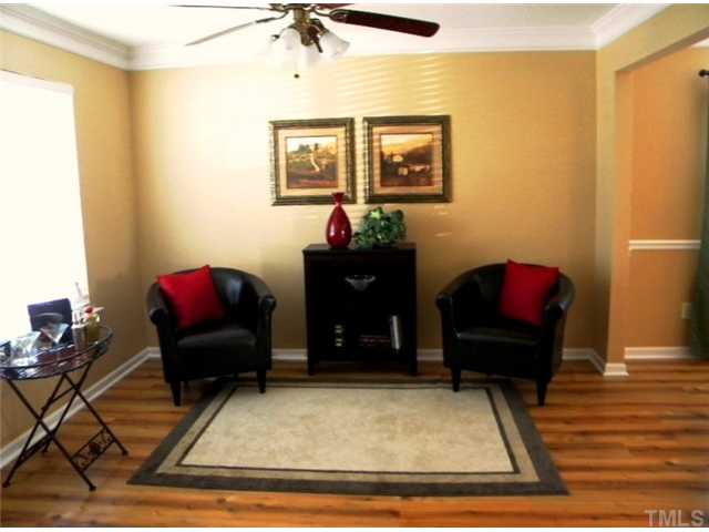 4613 Marathon Lane Raleigh, NC 27616 - Photo 4 of 24 LIving room includes 2 piece crown molding and ceiling fan.