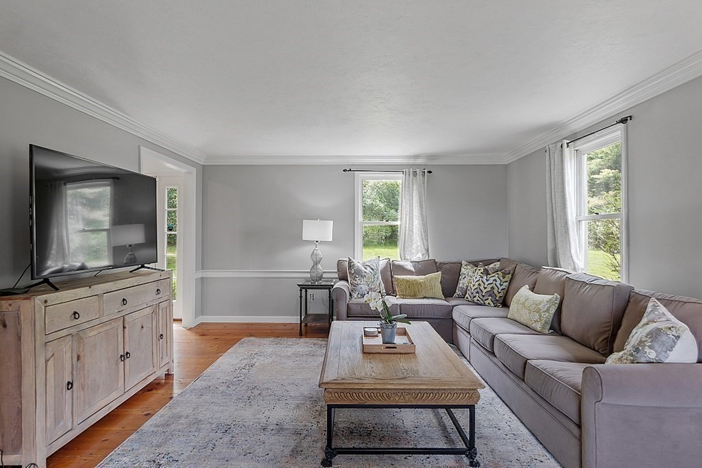 198 Still River Road Bolton, MA 01740 - Photo 20 of 36 a living room with furniture and a flat screen tv